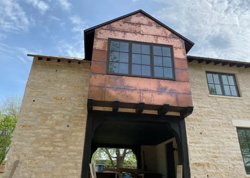 Copper metal panel facade on a stone building for Metal Roof Coating in Auburndale