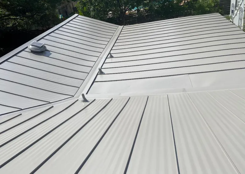 Solar attic fan installed on a metal roof for Roof Ventilation in Auburndale